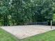 An outdoor sand volleyball court surrounded by lush greenery at 200 Greensview Dr, Cary, NC 27518