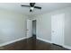 A neutral-colored bedroom has dark hardwood floors and a ceiling fan at 2112 Mckinney St, Burlington, NC 27217