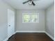 This bedroom has a window with views and dark hardwood floors at 2112 Mckinney St, Burlington, NC 27217