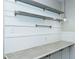 Counter with white cabinets, shelving, tile backsplash and stainless steel hardware at 2112 Mckinney St, Burlington, NC 27217