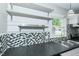 Updated kitchen with stainless shelving, granite countertops, tiled backsplash, and window overlooking the yard at 2112 Mckinney St, Burlington, NC 27217