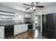 Remodeled kitchen with wood floors, white cabinets, black appliances and stainless steel range at 2112 Mckinney St, Burlington, NC 27217