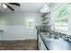 Kitchen features white cabinets, stainless sink and open shelving for storage at 2112 Mckinney St, Burlington, NC 27217