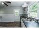 Kitchen features white cabinets, stainless sink and open shelving for storage at 2112 Mckinney St, Burlington, NC 27217