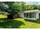 Large, green backyard with privacy fence, and the exterior of the home, including sunroom and screened porch at 2821 Regent Park Ln, Burlington, NC 27217