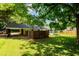 Backyard featuring a covered carport, fenced yard, and enclosed porch at 2821 Regent Park Ln, Burlington, NC 27217