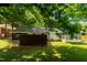 Fenced backyard with grassy lawn and a screened porch offers private outdoor space at 2821 Regent Park Ln, Burlington, NC 27217
