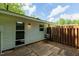 Cozy patio area beside the house, leading to a fenced backyard with green spaces at 2821 Regent Park Ln, Burlington, NC 27217