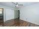 Bedroom showcasing hardwood floors, ceiling fan, closet, and doorway to bathroom at 2821 Regent Park Ln, Burlington, NC 27217
