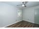 Bright bedroom featuring wood-look floors, ceiling fan, and a neutral paint color at 2821 Regent Park Ln, Burlington, NC 27217