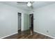 Bedroom showcasing wood-look floors, ceiling fan, closet and doorway at 2821 Regent Park Ln, Burlington, NC 27217