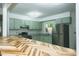 Eat-in kitchen featuring sage-green cabinets, granite counters, and stainless appliances at 2821 Regent Park Ln, Burlington, NC 27217
