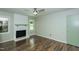 Bright living room with wood floors, a ceiling fan, and a painted brick fireplace at 2821 Regent Park Ln, Burlington, NC 27217
