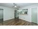 Bright living room with wood floors, a ceiling fan, and a view of the eat-in kitchen at 2821 Regent Park Ln, Burlington, NC 27217
