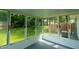 Enclosed sunroom with sliding glass windows provides a tranquil view of the green backyard at 2821 Regent Park Ln, Burlington, NC 27217