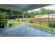 A screened-in porch offers peaceful outdoor living space with a view of the fenced yard at 2821 Regent Park Ln, Burlington, NC 27217
