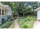 Landscaped backyard includes a patio with outdoor seating, green grass, and shade trees at 3509 Crofton Ct, Raleigh, NC 27604
