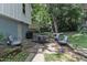 Backyard with patio featuring outdoor seating, lush landscaping, a green lawn, and mature trees at 3509 Crofton Ct, Raleigh, NC 27604