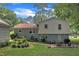 Home's backyard features a patio with outdoor seating, lush landscaping, and a well-maintained lawn at 3509 Crofton Ct, Raleigh, NC 27604