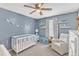 Bedroom with crib, chair, and cloud decor at 3509 Crofton Ct, Raleigh, NC 27604