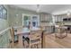 Inviting dining area with wood table and chairs next to updated kitchen with stainless steel appliances at 3509 Crofton Ct, Raleigh, NC 27604