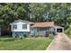 Charming split-level home with a detached garage, landscaped front yard, and mature trees at 3509 Crofton Ct, Raleigh, NC 27604