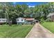 Split-level home with a long driveway leading to a detached garage, plus a spacious, well-kept lawn at 3509 Crofton Ct, Raleigh, NC 27604