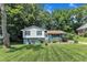 Charming split-level home featuring a well-manicured front lawn, mature trees and pleasant curb appeal at 3509 Crofton Ct, Raleigh, NC 27604