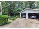 Detached two-car garage featuring an extended driveway and partial view of the backyard landscaping at 3509 Crofton Ct, Raleigh, NC 27604