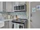 Well-appointed kitchen with stainless steel appliances, granite counters, stylish backsplash, and updated fixtures at 3509 Crofton Ct, Raleigh, NC 27604