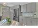 Modern kitchen with stainless steel appliances, granite countertops, custom cabinets, and ample storage at 3509 Crofton Ct, Raleigh, NC 27604