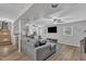 Open-concept living room with comfortable seating, a large TV, and natural light at 3509 Crofton Ct, Raleigh, NC 27604