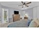 Main bedroom with ensuite bathroom, dresser with TV, and neutral carpet at 3509 Crofton Ct, Raleigh, NC 27604