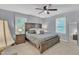 Spacious main bedroom featuring a ceiling fan, two windows and a large bed at 3509 Crofton Ct, Raleigh, NC 27604