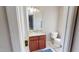 Bathroom with a brown vanity, white toilet, and a mirror with decorative lighting for a welcoming ambiance at 417 Downing Glen Dr, Morrisville, NC 27560