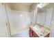 Bathroom with a tub shower, a brown vanity with quartz top, and a decorative mirror with modern lighting at 417 Downing Glen Dr, Morrisville, NC 27560