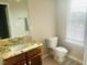 Cozy bathroom features a single sink vanity and a toilet nearby a bright window at 417 Downing Glen Dr, Morrisville, NC 27560