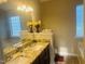 Bathroom with a double sink vanity with granite countertops, and a glass block window at 417 Downing Glen Dr, Morrisville, NC 27560
