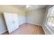 Bright bedroom featuring a ceiling fan, a spacious closet, and beautiful hardwood floors at 417 Downing Glen Dr, Morrisville, NC 27560