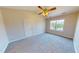 Spacious bedroom features a window, ceiling fan, and neutral color pallete at 417 Downing Glen Dr, Morrisville, NC 27560
