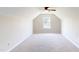 A spacious bonus room featuring neutral-toned walls, a ceiling fan, and a window for natural light at 417 Downing Glen Dr, Morrisville, NC 27560
