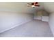 Expansive carpeted bonus room features a ceiling fan, neutral walls, and natural light at 417 Downing Glen Dr, Morrisville, NC 27560