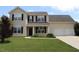 Charming two-story home featuring black shutters, a two-car garage, and a well-manicured front lawn at 417 Downing Glen Dr, Morrisville, NC 27560