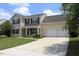 Charming two-story home with a well-manicured lawn and a spacious two-car garage at 417 Downing Glen Dr, Morrisville, NC 27560