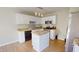Modern kitchen with white cabinetry, granite countertops, stainless steel appliances, and central island at 417 Downing Glen Dr, Morrisville, NC 27560