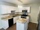 Bright kitchen featuring granite countertops, stainless steel appliances, and an island at 417 Downing Glen Dr, Morrisville, NC 27560