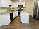 Updated kitchen boasts white cabinets, stainless appliances, and granite countertops at 417 Downing Glen Dr, Morrisville, NC 27560