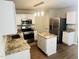 Bright kitchen with white cabinetry, stainless steel appliances and stone countertops at 417 Downing Glen Dr, Morrisville, NC 27560