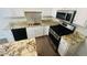 The kitchen features stainless appliances, stylish backsplash and granite countertops at 417 Downing Glen Dr, Morrisville, NC 27560