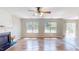 Bright living room with a fireplace, wood floors, and lots of natural light from large windows at 417 Downing Glen Dr, Morrisville, NC 27560